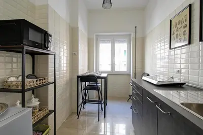 a kitchen with a counter and a stool in it at Residenza Santa Barbara in Rome
