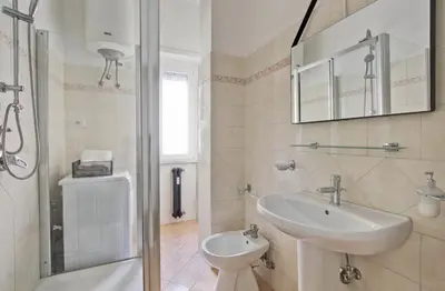 a bathroom with a sink and a toilet and a shower at Residenza Santa Barbara in Rome