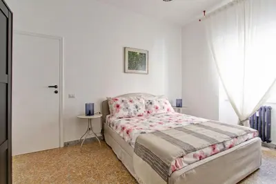 a bedroom with a bed and a table and a window at Residenza Santa Barbara in Rome