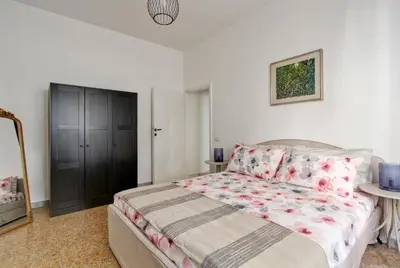 a bedroom with a bed and a black cabinet at Residenza Santa Barbara in Rome
