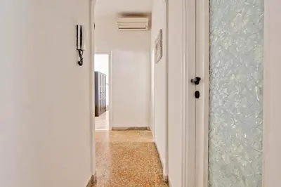 a hallway with a glass door and a hallway with a tile floor at Residenza Santa Barbara in Rome
