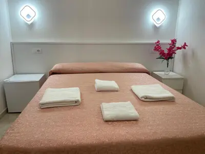 a bedroom with a bed with two towels on it at Mille Guest house 2 in Rome