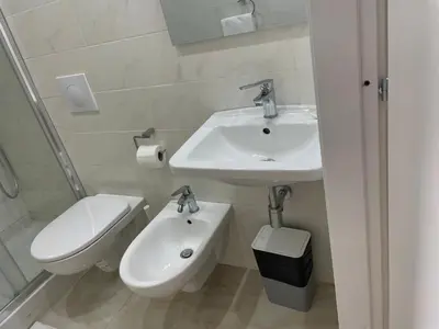 a bathroom with a sink and a toilet and a mirror at Mille Guest house 2 in Rome