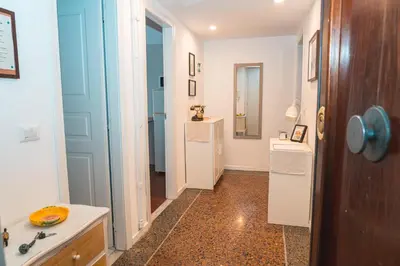 a hallway with a bathroom with a sink and a mirror at Il giardino di San Pietro - 10 minuti dai Musei Vaticani in Rome