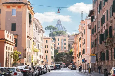 a city street with cars parked on the street at Il giardino di San Pietro - 10 minuti dai Musei Vaticani in Rome