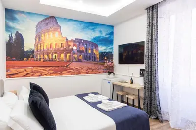 a hotel room with a picture of a building at Susy's Guest House - Room Colosseo in Rome
