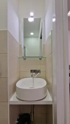 a white sink in a bathroom with a mirror at Susy's Guest House - Room Colosseo in Rome