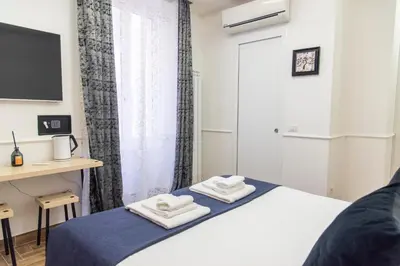 a bedroom with a bed with two towels on it at Susy's Guest House - Room Colosseo in Rome