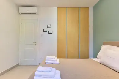 a bedroom with a bed with towels on it at Oasi Piceni Apartment San Lorenzo in Rome