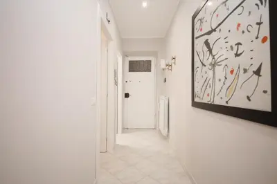 a hallway with white walls and a painting on the wall at Rome Flat 42 by GHOR in Rome