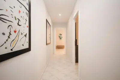 a hallway with white walls and art on the walls at Rome Flat 42 by GHOR in Rome