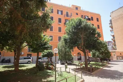 an orange building with trees in front of it at Rome Flat 42 by GHOR in Rome