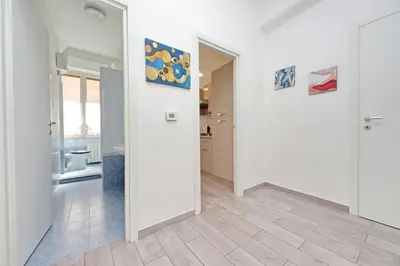 a hallway with white walls and tile floors in a house at 4BNB - Cavalleggeri Apartment in Rome
