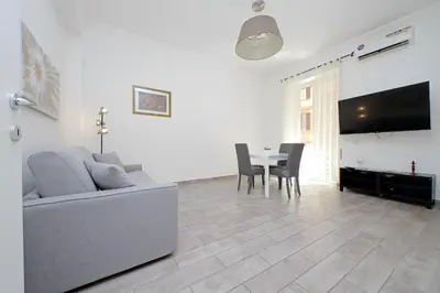 a living room with a couch and a table at 4BNB - Cavalleggeri Apartment in Rome