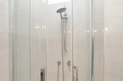 a shower with a shower head in a bathroom at 4BNB - Lante Apartment in Rome