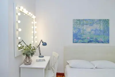 a room with a bed and a table with a mirror at 4BNB - Lante Apartment in Rome