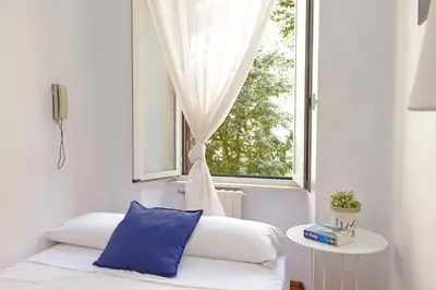 a room with a couch and a window at 4BNB - Lante Apartment in Rome