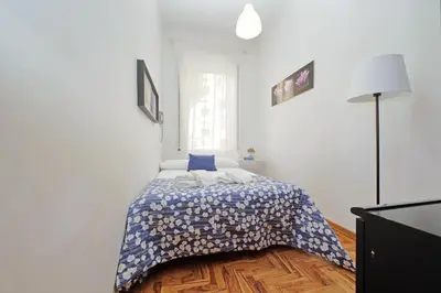 a bedroom with a bed with a blue comforter at 4BNB - Lante Apartment in Rome