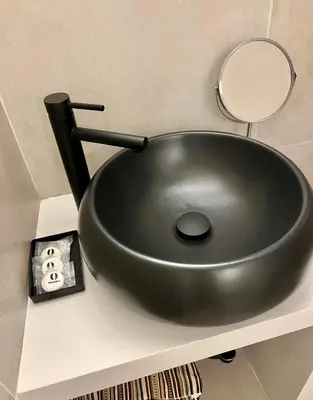 a black sink sitting on a shelf with a mirror at Charming Navona - The Loft in Rome