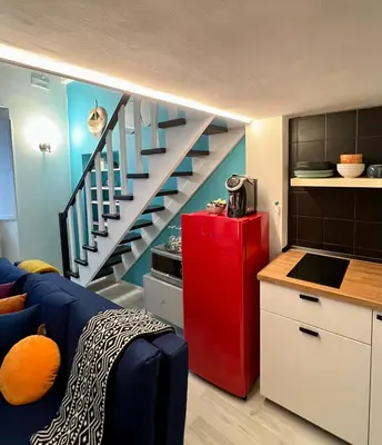 a kitchen with a red refrigerator and a staircase at Charming Navona - The Loft in Rome
