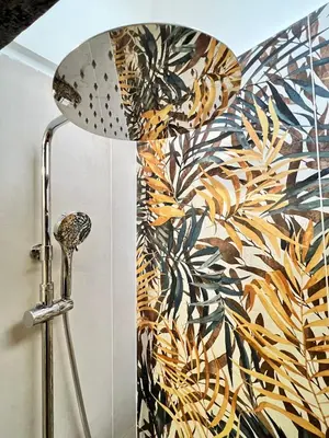 a shower head in a bathroom with a patterned wall at Charming Navona - The Loft in Rome