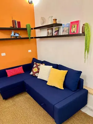 a blue couch with pillows on it in a room at Charming Navona - The Loft in Rome