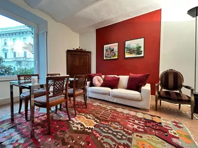 a living room with a couch and a table at Elegant 3 bedrooms apartment Colosseum - San Giovanni in Rome