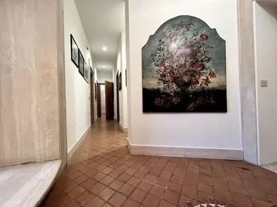 a hallway with a large painting on the wall at Elegant 3 bedrooms apartment Colosseum - San Giovanni in Rome