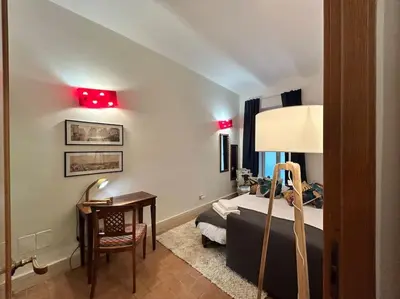 a bedroom with a bed and a desk and red lights at Elegant 3 bedrooms apartment Colosseum - San Giovanni in Rome