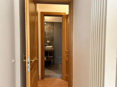 a door leading to a bathroom with a sink at Elegant 3 bedrooms apartment Colosseum - San Giovanni in Rome