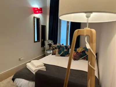 a bedroom with a bed with a lamp and a window at Elegant 3 bedrooms apartment Colosseum - San Giovanni in Rome