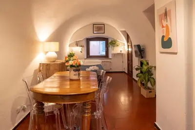 a dining room with a wooden table and chairs at Arco del Calidarium - Pantheon in Rome