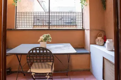 a table and a chair in front of a window at Arco del Calidarium - Pantheon in Rome