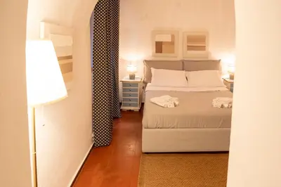 a small bedroom with a bed and a lamp at Arco del Calidarium - Pantheon in Rome