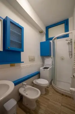 a bathroom with a toilet and a sink and a shower at Richard & Lulù in Rome in Rome