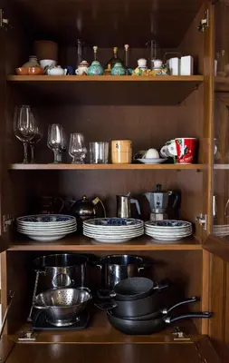 a shelf with plates and dishes in a kitchen at Richard & Lulù in Rome in Rome