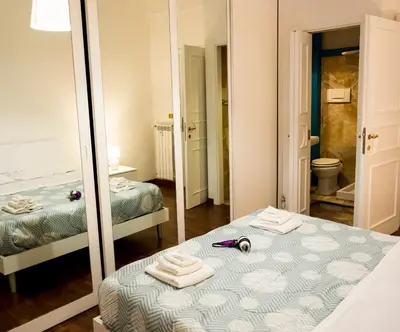 a bedroom with two beds and a mirror at Richard & Lulù in Rome in Rome