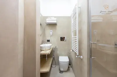 a bathroom with a toilet and a sink at Gemma House - 100mt to Metro Station, 2 En-Suite bathrooms in Rome