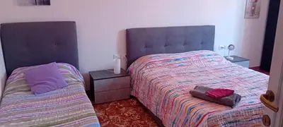 a bedroom with a bed and a nightstand next to at Cosy Apartment - 5 Minutes Walk from Colosseum in Rome