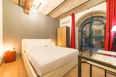 a bedroom with a bed and a glass table at Appartamento via di Montegiordano in Rome