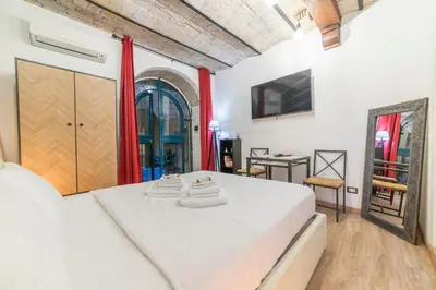 a bedroom with two white beds and a table at Appartamento via di Montegiordano in Rome