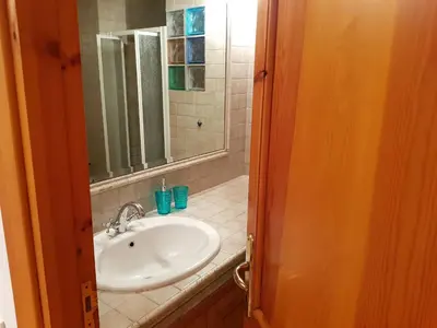 a bathroom with a sink and a mirror at Appartamento via di Montegiordano in Rome