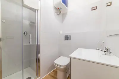 a bathroom with a shower and a toilet and a sink at Appartamento via di Montegiordano in Rome