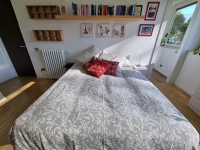 a bedroom with a large bed with red pillows at Parco della Musica House in Rome