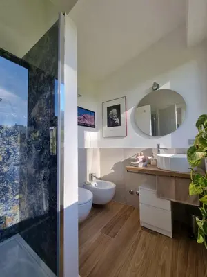 a bathroom with two sinks and a mirror at Parco della Musica House in Rome