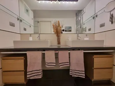 a bathroom with two sinks and two mirrors at Parco della Musica House in Rome