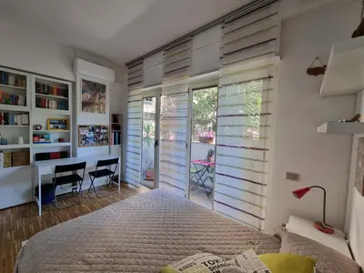 a bedroom with a bed and a desk at Parco della Musica House in Rome