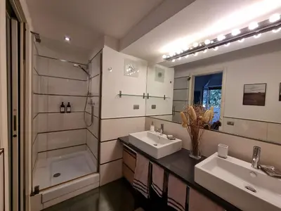 a bathroom with two sinks and a shower and a tub at Parco della Musica House in Rome
