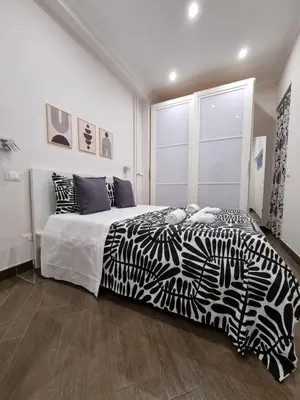a bedroom with a zebra print bed and a window at Relais Viola at the Vatican in Rome