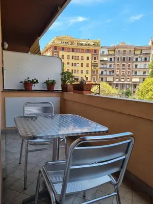 a table and two chairs on a balcony at Relais Viola at the Vatican in Rome